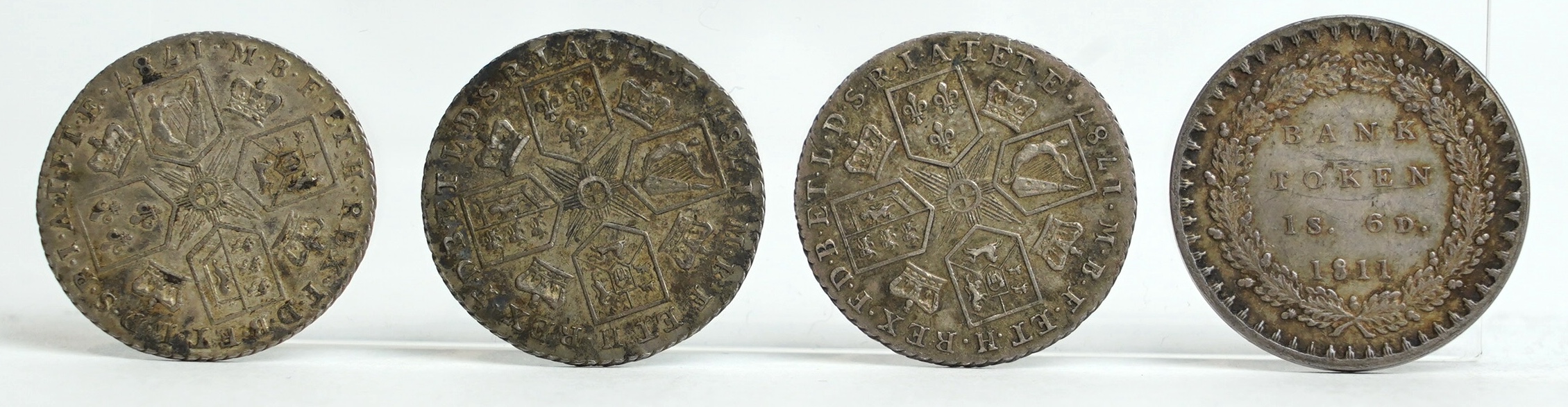 British silver coins, George III, three shilling coins, 1787, good VF to about EF, and Bank token eighteenpence (1S.6D.) 1811, near EF (4)